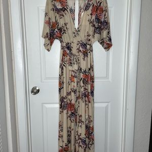 floral jumpsuit low neckline & small oval shape open back.
